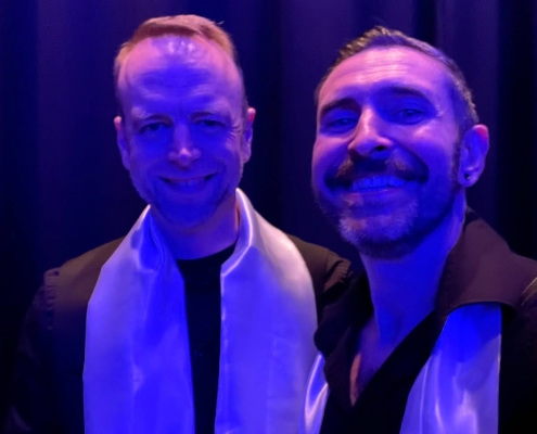 Two men standing in blue light